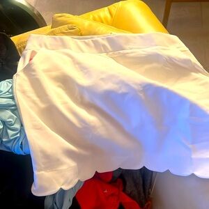 Like new- white, scalloped bottom golf skirt with shorts and pockets